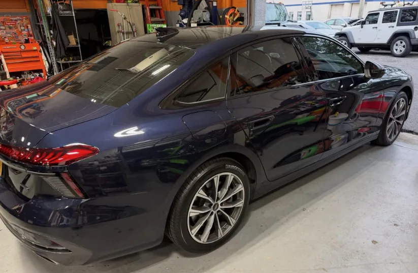 Dark sedan with freshly installed window tint at NY Window Tinting
