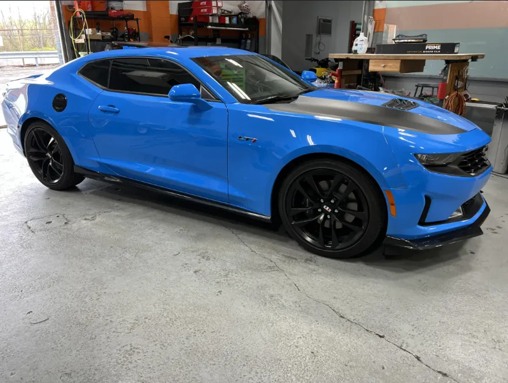 Blue Camaro with window tint installed at NY Window Tinting shop