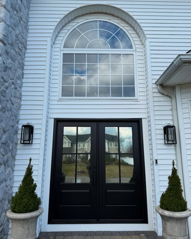 Home with tinted arched double front doors